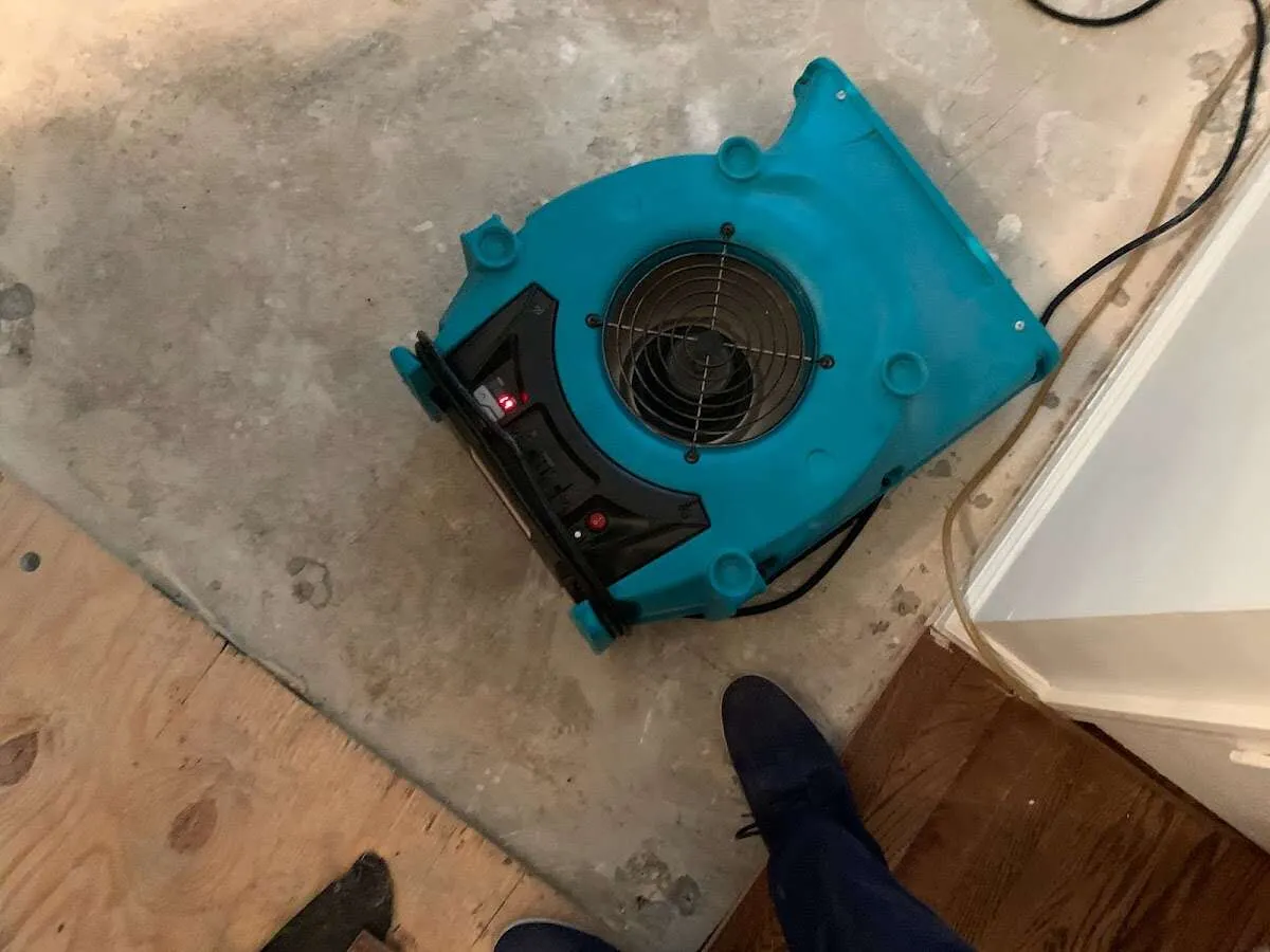 Air mover drying subfloor during Commercial Water Damage Restoration in Lakemoor